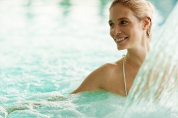 Woman enjoying the water jet at a spa