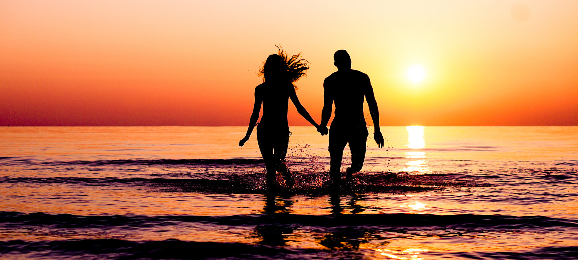Couple enjoying sunset on the beach