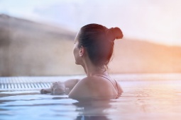 A tourist in an outdoor thermal bath