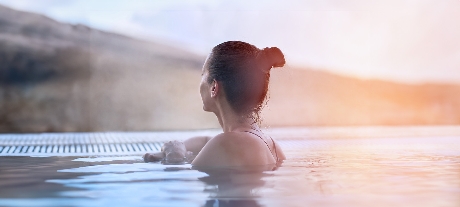 A tourist in an outdoor thermal bath