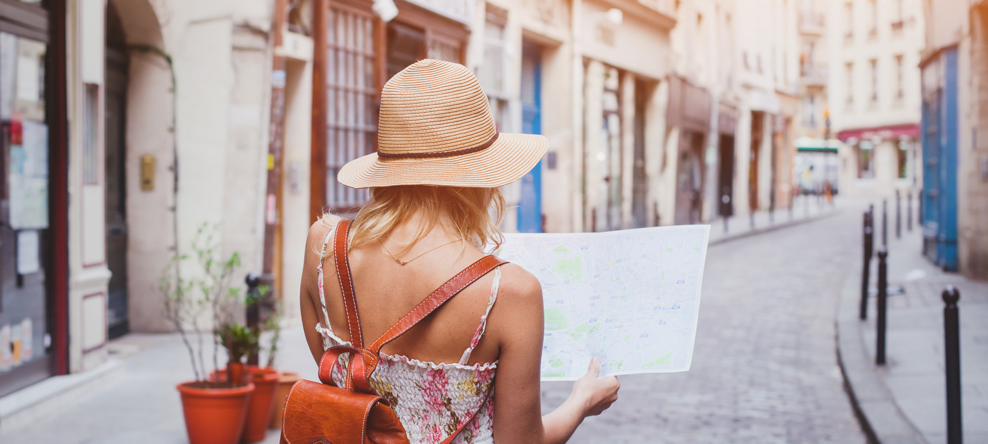 A tourist walking around a city with a map