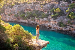 Tourist contemplating Cala Pi in Mallorca, Balearic Islands