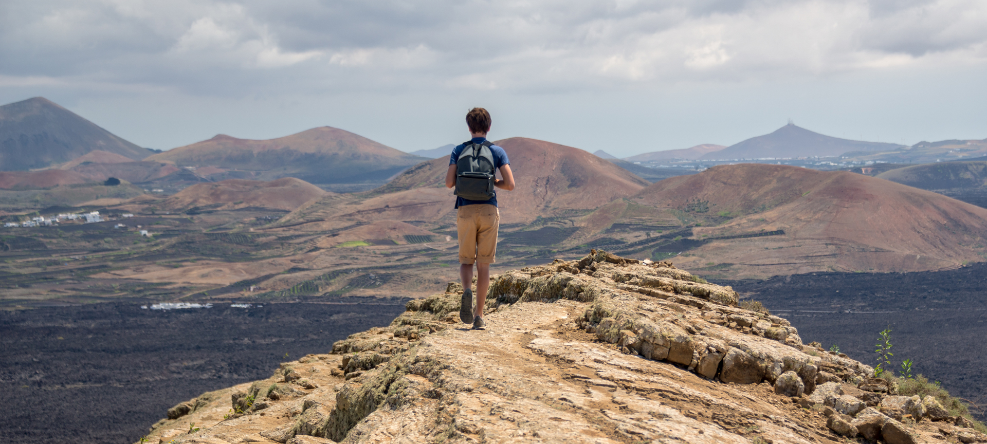 A tourist walking along the Caldera Blanca trail in Lanzarote, Canary Islands