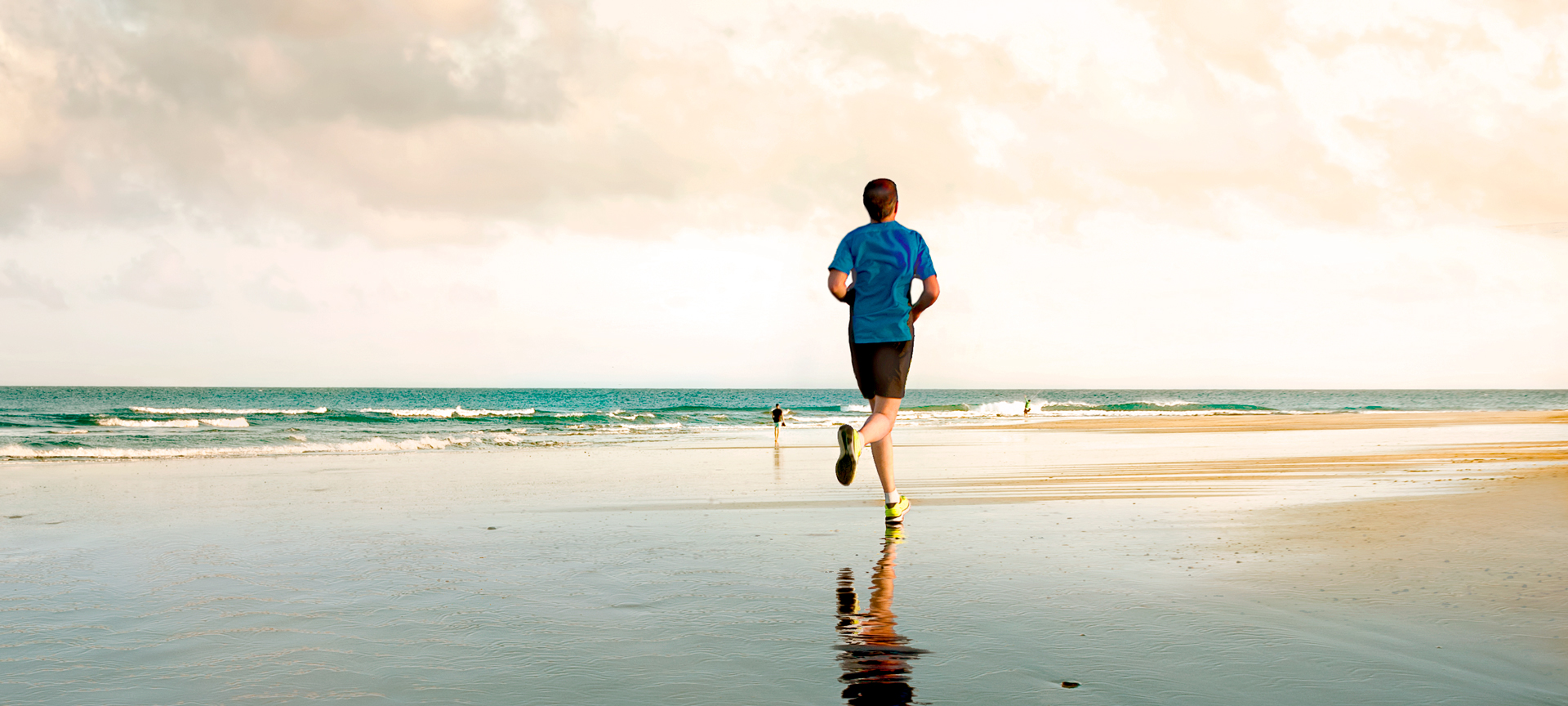 Young person running on Maspalomas beach in Gran Canaria, Canary Islands