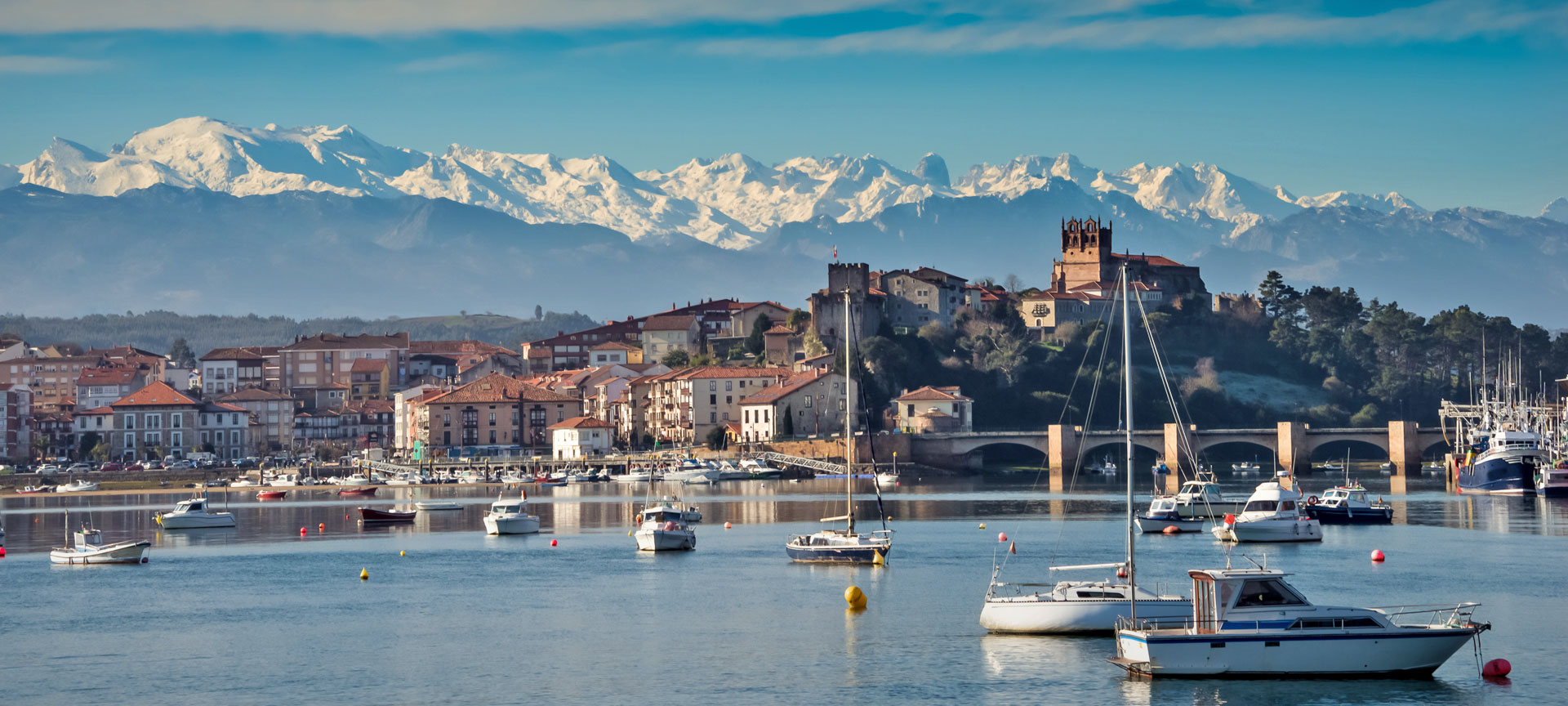 San Vicente de la Barquera with Los Picos de Europa mountains in the background. Cantabria