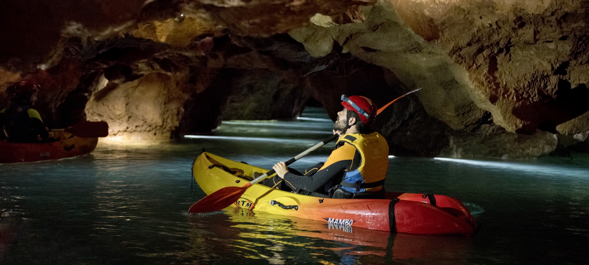 Tourist practising speleokayak in the Coves de Sant Josep de La Vall d'Uixó in Castellón, Region of Valencia.