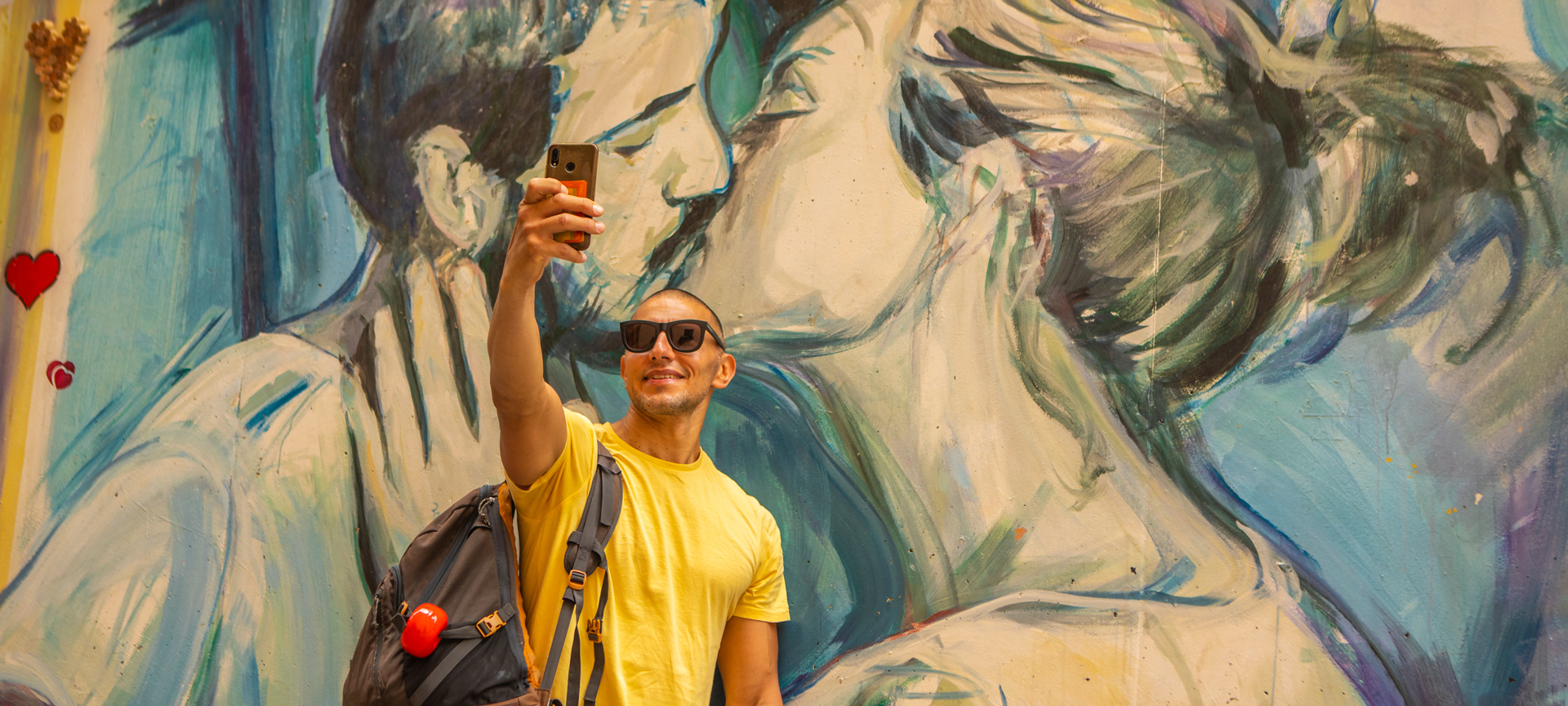 Tourist taking a selfie at a graffiti in Valencia, Region of Valencia