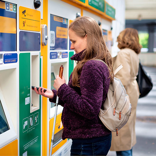 Visually impaired tourist buying a train ticket