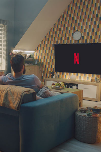 Short film competition_Someone in their living room with Netflix on TV © Frame Stock Footage