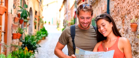 Couple strolling through the streets of Valldemossa in Mallorca, Balearic Islands Couple strolling through the streets of Valldemossa in Mallorca, Balearic Islands
