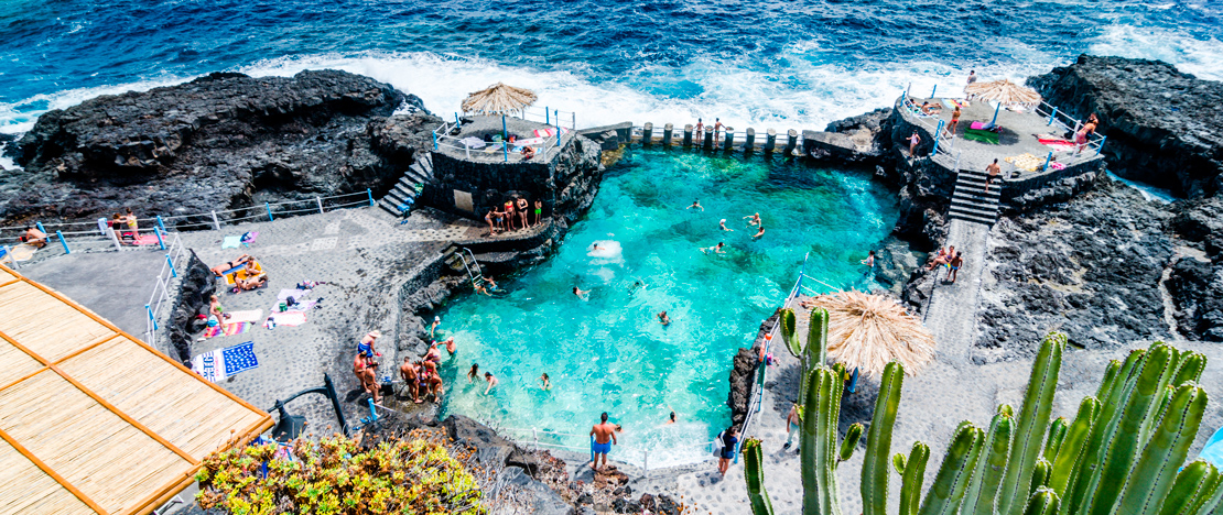 Tourists bathing in the Charco Azul natural pool on La Palma, Canary Islands Tourists bathing in the Charco Azul natural pool on La Palma, Canary Islands