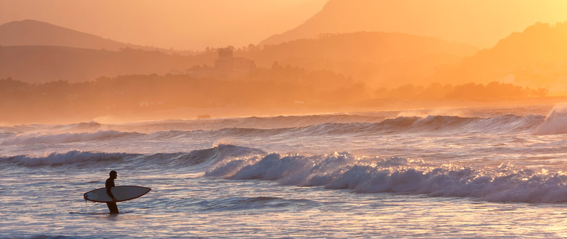 Surfer on the beach at San Vicente de la Barquera (Cantabria)