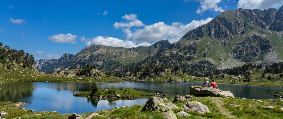 Des randonneurs se reposant au bord du lac de Colomers dans le parc national d'Aigüestortes i Estany de Sant Maurici, Lérida, Catalogne
