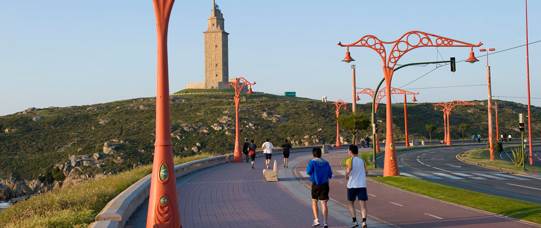 People running and walking along the seaside promenade in A Coruña