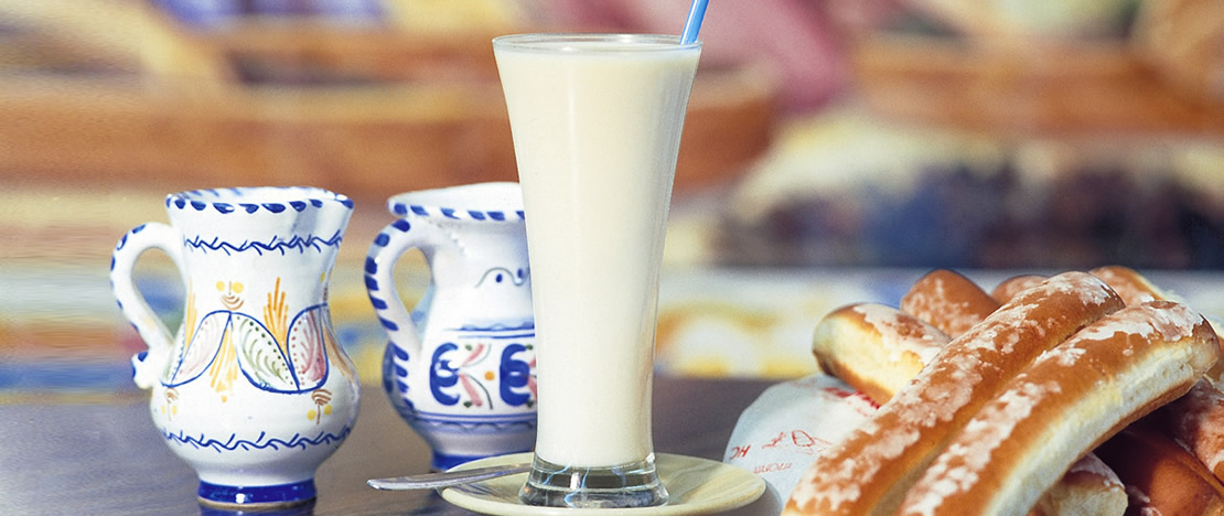 Glass of horchata and fartons Glass of horchata and fartons