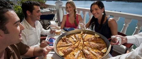 Friends eating paella Friends eating paella