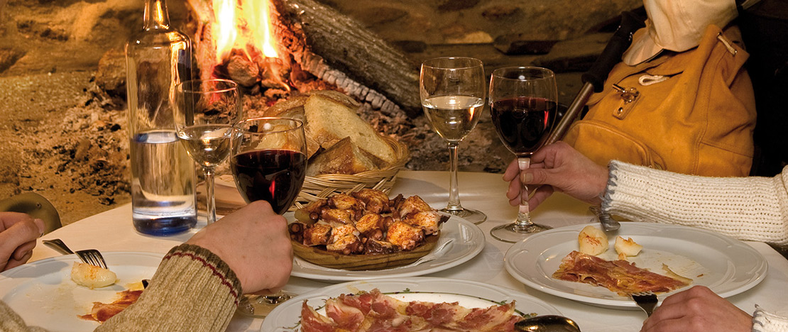 Couple enjoying wine and various tapas