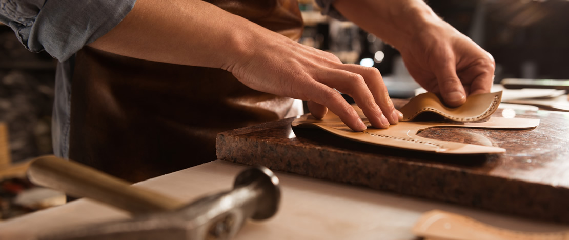 Craftsman making leather products Craftsman making leather products