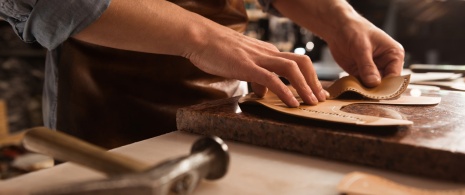Craftsman making leather products Craftsman making leather products
