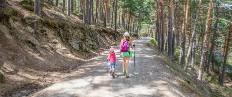 A mother and daughter hiking in Puerto de Canencia A mother and daughter hiking in Puerto de Canencia