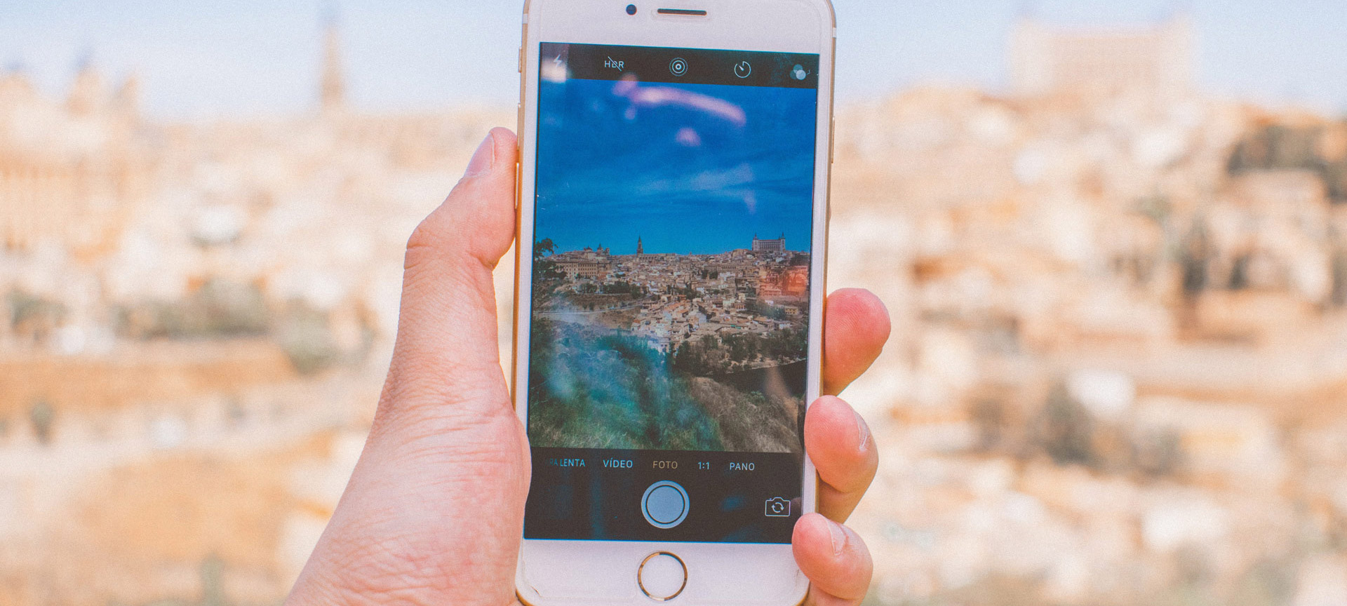 Person taking a photo of Toledo on their phone