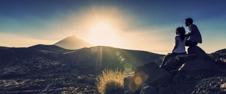Paar beim Betrachten des Sonnenuntergangs auf dem Teide Paar beim Betrachten des Sonnenuntergangs auf dem Teide
